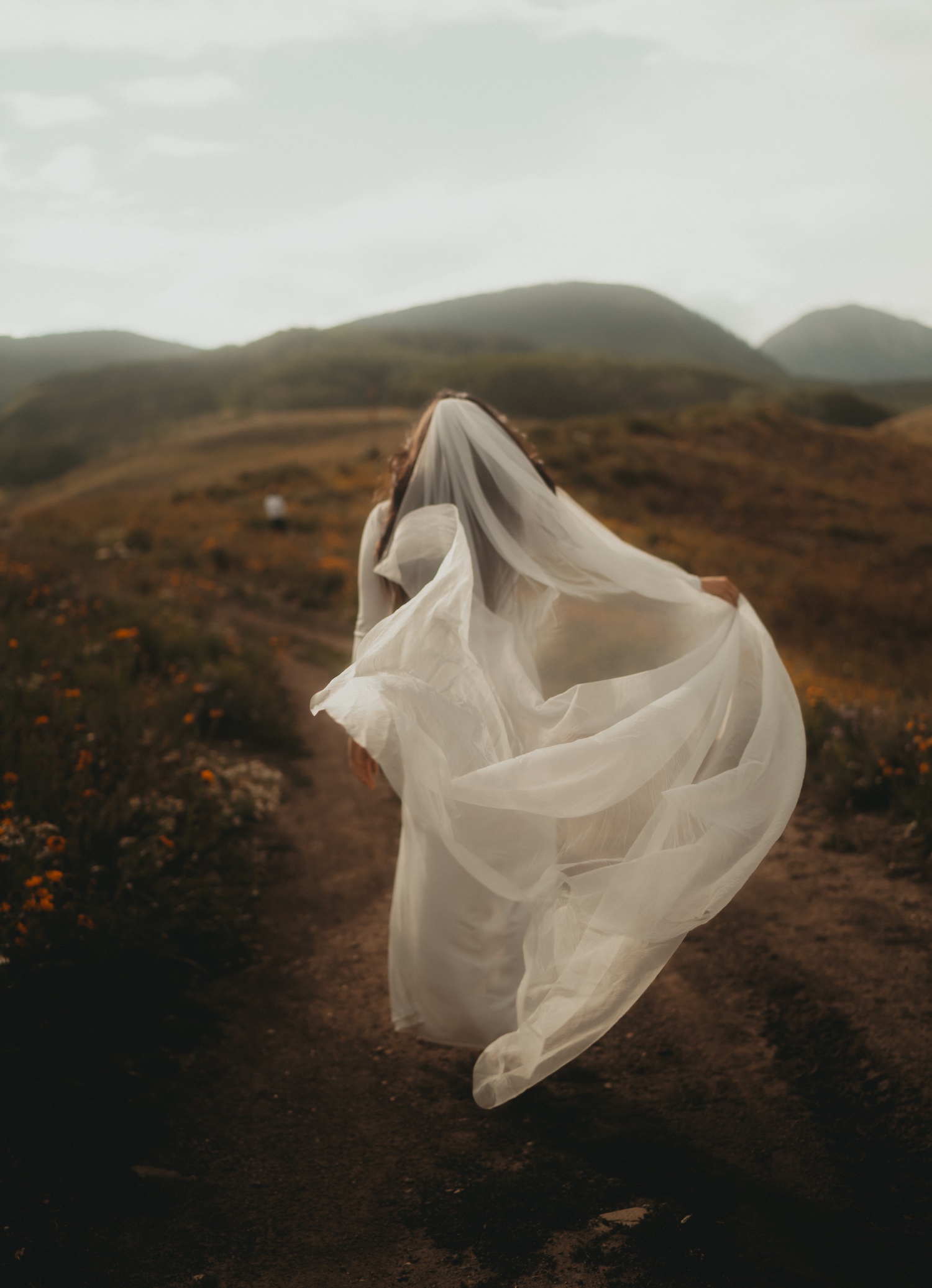 Crested butte colorado bride surrounded by wildflowers and mountains